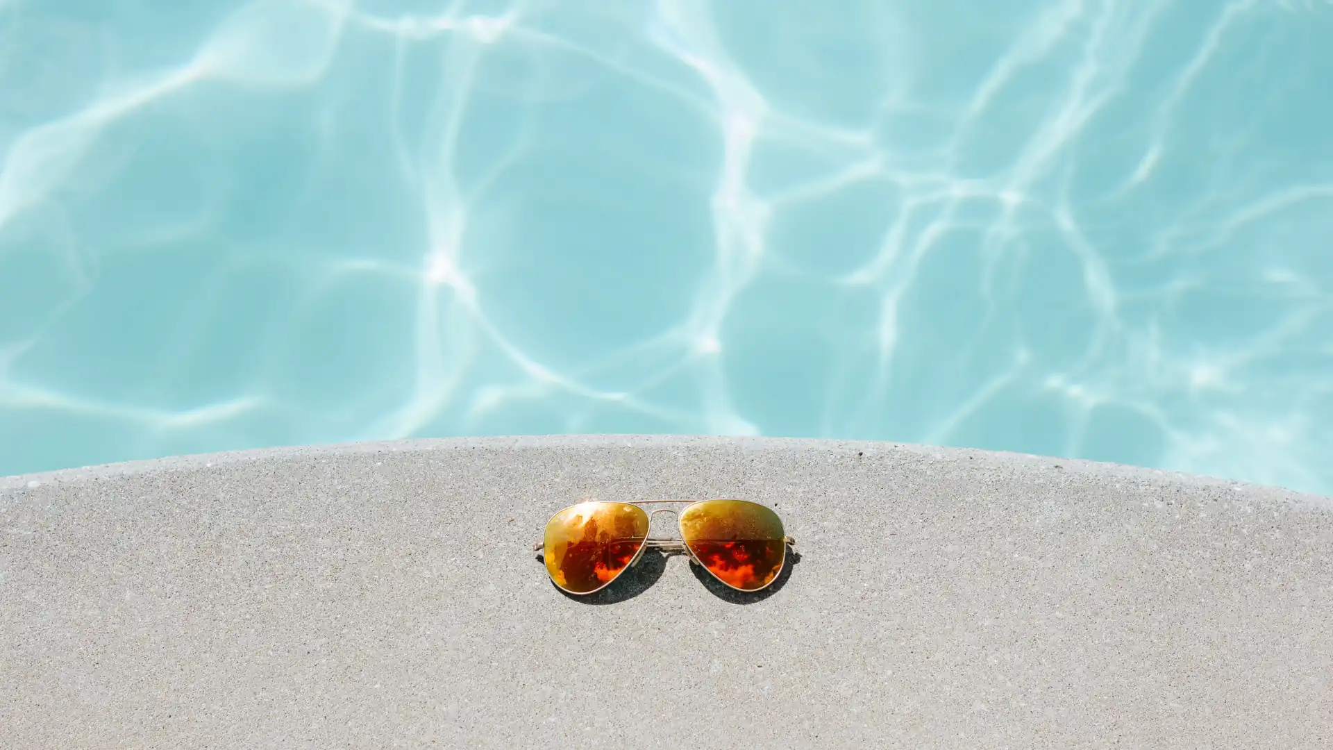 How much does a concrete pool cost – Sunglasses by the edge of a pool